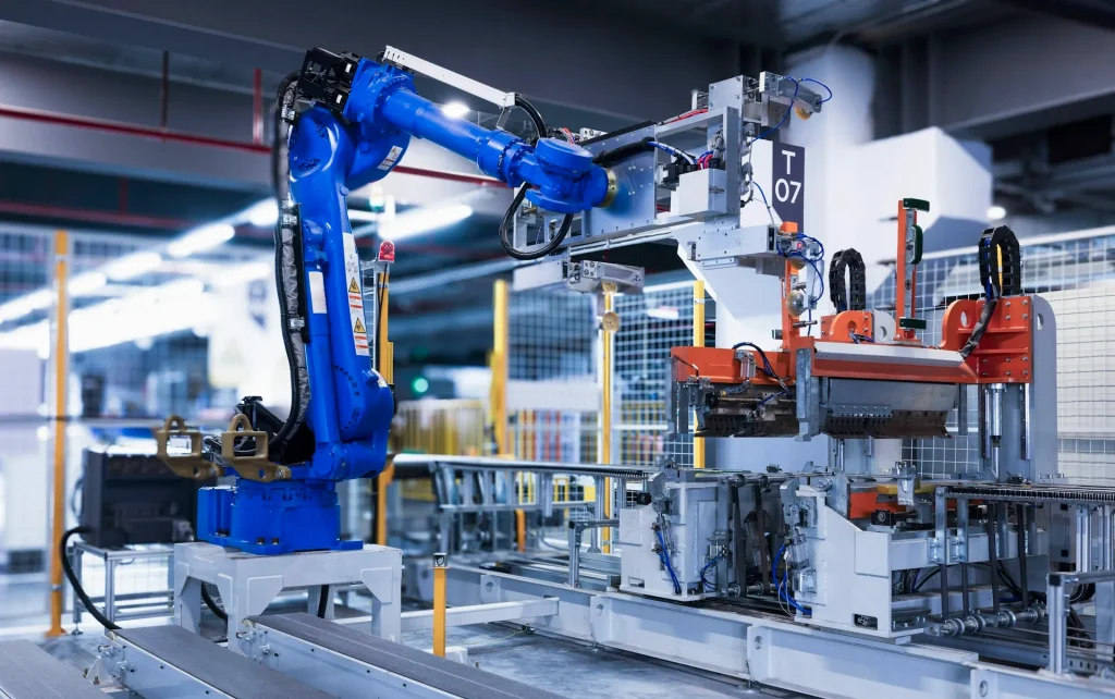 Blue robotic arm integrated into an automated assembly line
